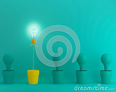 Outstanding yellow light bulbs with glowing in flowerpot one different idea from light bulbs the others on green pastel background Stock Photo