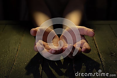 Outstretched arms forward. Outstretched palms forward. Empty palms. Front view. Low key. Stock Photo