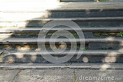 Outworn old gray stone stairs outdoor in the sunlight Stock Photo