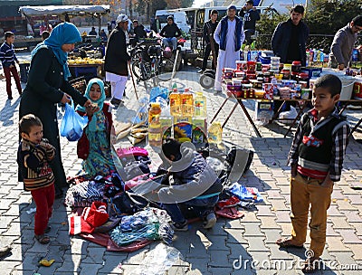 Unidentified Afghan Woman buying Clothes at Farmers Market in Ovakent, Hatay, Turkey Editorial Stock Photo