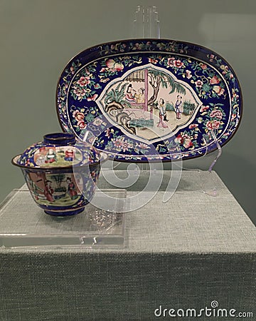 Oval tea tray and tureen patterned with figures and copper tire painted enamel twined flowers and fruits Editorial Stock Photo