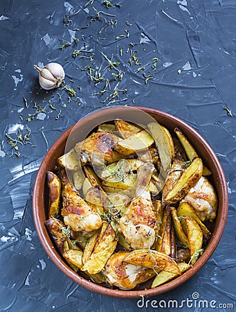 Oven baked chicken legs with vegetables potatoes, herbs and spices in baking dish Stock Photo