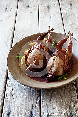 Oven baked quails served with berry sauce Stock Photo