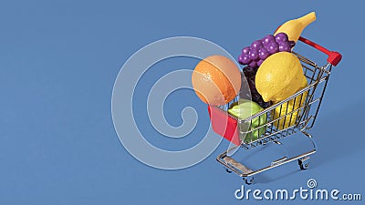 Over filled shopping cart with fruits and vegetables Stock Photo