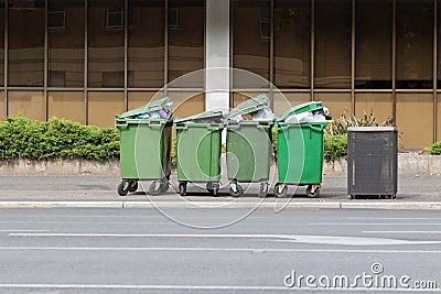 Over filled Wheelie bins, waste containers full of trash on foot Stock Photo