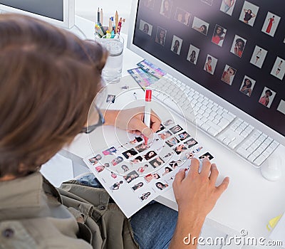 Over head of editor marking contact sheet Stock Photo