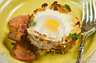 Egg in potato nest with bacon Stock Photo