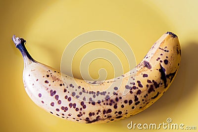 Over riped banana on yellow plate Stock Photo