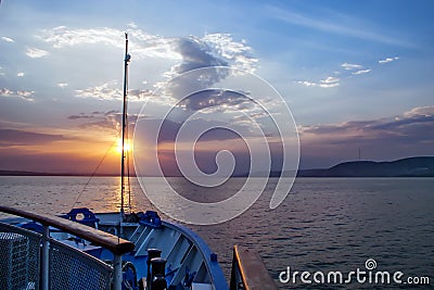 Over the river the sun rises, reflected in the mirrored surface of the water Stock Photo