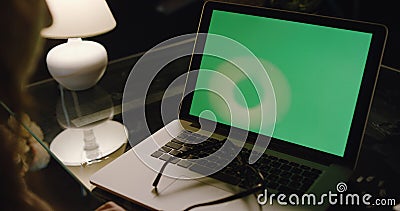 Over the shoulder shot of a business woman working in the evening Stock Photo