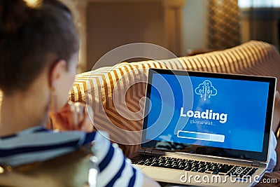 Healthy woman looking at computer loading screen on laptop Stock Photo