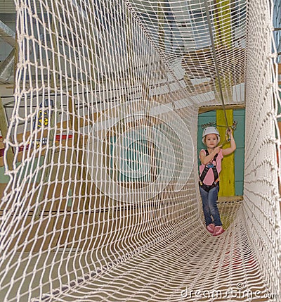 Overcomes obstacles mesh, the adventure Park the kid in the whit Stock Photo