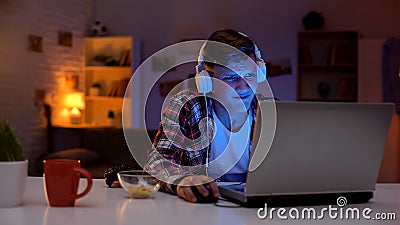 Overemotional teen boy losing video game, inadequate emotional reaction, addict Stock Photo