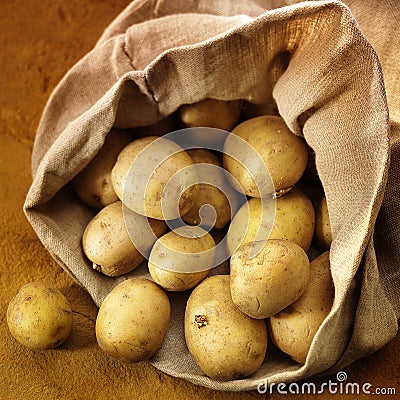 Overflowing bag of potatos Stock Photo