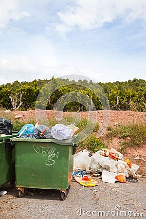 Overflowing bins next to Orange Orchard, Valencia region, Spain Editorial Stock Photo