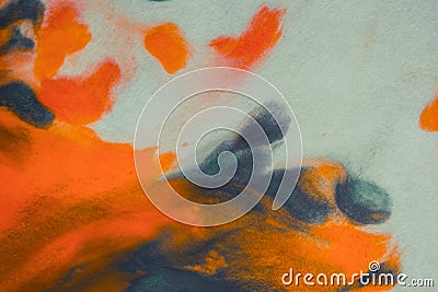 Overflowing bright orange and dark blue paint on paper Stock Photo