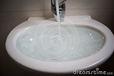 Overflowing kitchen sink, clogged drain. Stock Photo