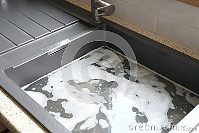 Overflowing kitchen sink, clogged drain Stock Photo
