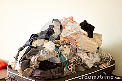 Overflowing laundry at home. COpy space. Messy real life. Chores Stock Photo