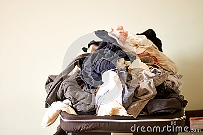 Overflowing laundry at home. COpy space. Messy real life. Chores Stock Photo