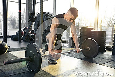 The male athlete training hard in the gym. Fitness and healthy life concept. Stock Photo