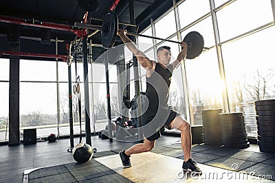 The male athlete training hard in the gym. Fitness and healthy life concept. Stock Photo