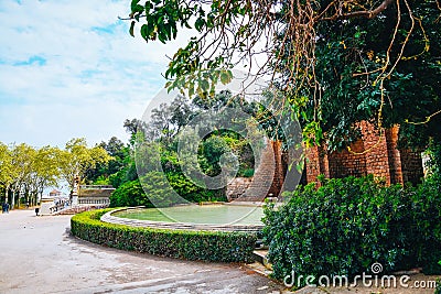 Overgrown pond and hedge in spring park of Barcelona. Part of famous Montjuic fountain near National art museum. Trimmed bushes, Editorial Stock Photo