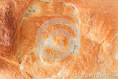 Overhead close view of the crust of a baked loaf of homemade bread illuminated with natural light Stock Photo