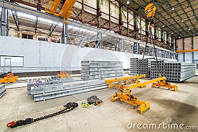 Overhead crane beam hoist concrete slab on a plant. Stock Photo