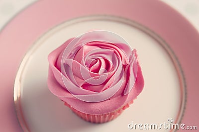 Overhead detail of pink rose frosted cupcake Stock Photo