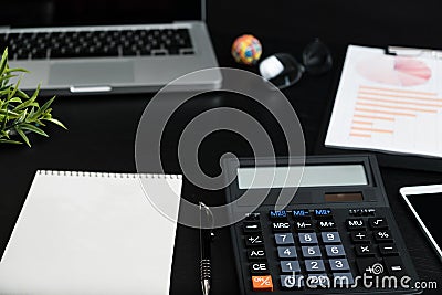 Overhead of office table with notebook, computer keyboard, calculator Stock Photo