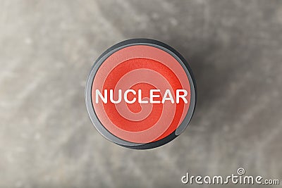 Overhead of Red Nuclear Push Button Over Blurred Gray Background Stock Photo