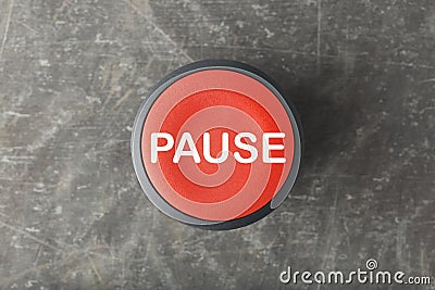 Overhead of Red Pause Push Button on Concrete Background Stock Photo