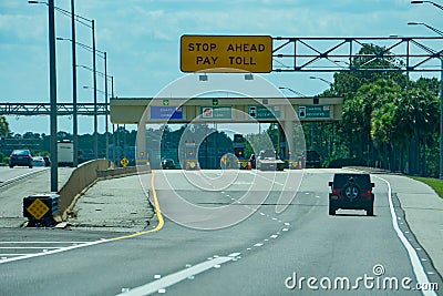 Overhead road direction signs found on the approach to toll plaza`s Editorial Stock Photo