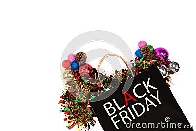 Overhead shot of black paper bag with black friday word and christmas decorations on white background. Stock Photo