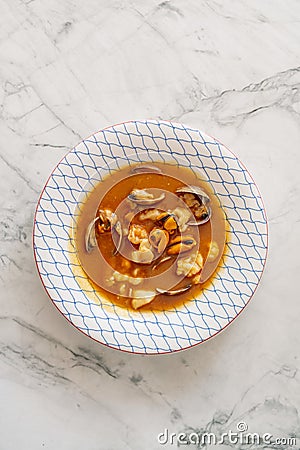 Overhead shot of a bowl of thick red seafood stew Stock Photo