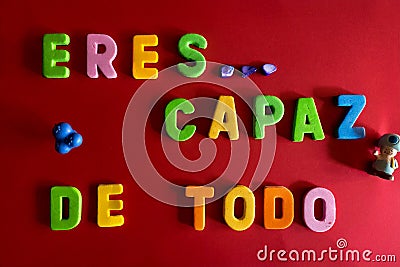 Overhead shot of colorful yellow toy letters eres capaz de todo Stock Photo