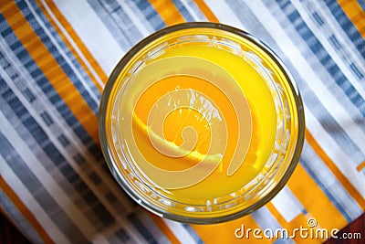 an overhead shot of a glass of orange juice with a squeezer Stock Photo