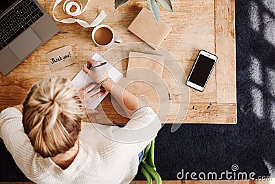 Overhead Shot Looking Down On Woman Writing In Generic Thank You Card Stock Photo