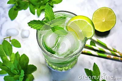 overhead shot of a mojito, lime wedges, and a muddler Stock Photo