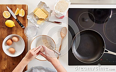 Overhead Shot Of Woman In Kitchen With Ingredients Making Pancakes Or Crepes For Pancake Day Stock Photo