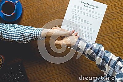 Overhead top view of two casual businessmen work in the office at table, toned Stock Photo