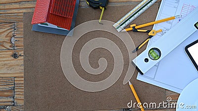 Architect workspace with blueprints, helmet and digital tablet. Stock Photo