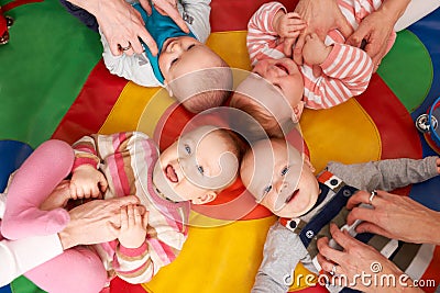 Overhead View Of Babies Having Fun At Nursery Playgroup Stock Photo