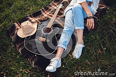 Overhead view of beautiful woman with guitar resting on green lawn. Top view Stock Photo