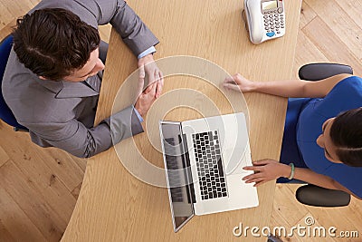 Overhead View Of Businesspeople Using Laptop In Office Stock Photo