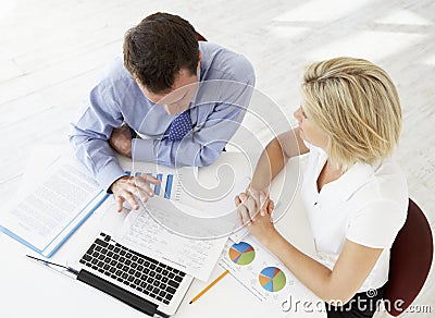 Overhead View Of Businesswoman And Businessman Working At Desk T Stock Photo