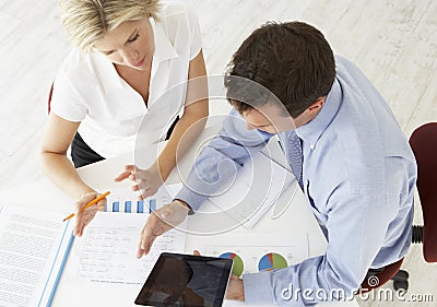 Overhead View Of Businesswoman And Businessman Working At Desk Together Stock Photo