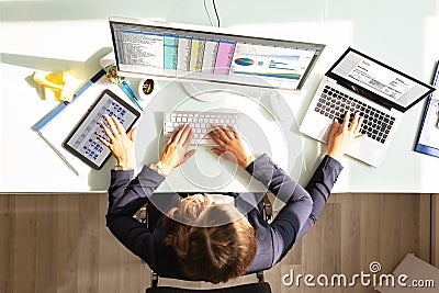 Businesswoman Doing Multitasking Work In Office Stock Photo
