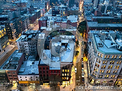 Overhead view of the busy streets of Nolita and SoHo neighborhoods with colorful night lights shining at dusk in New York City Stock Photo